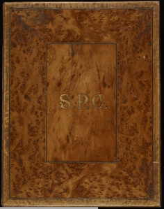 The mottled kauri cover of the illuminated address for Wallis.